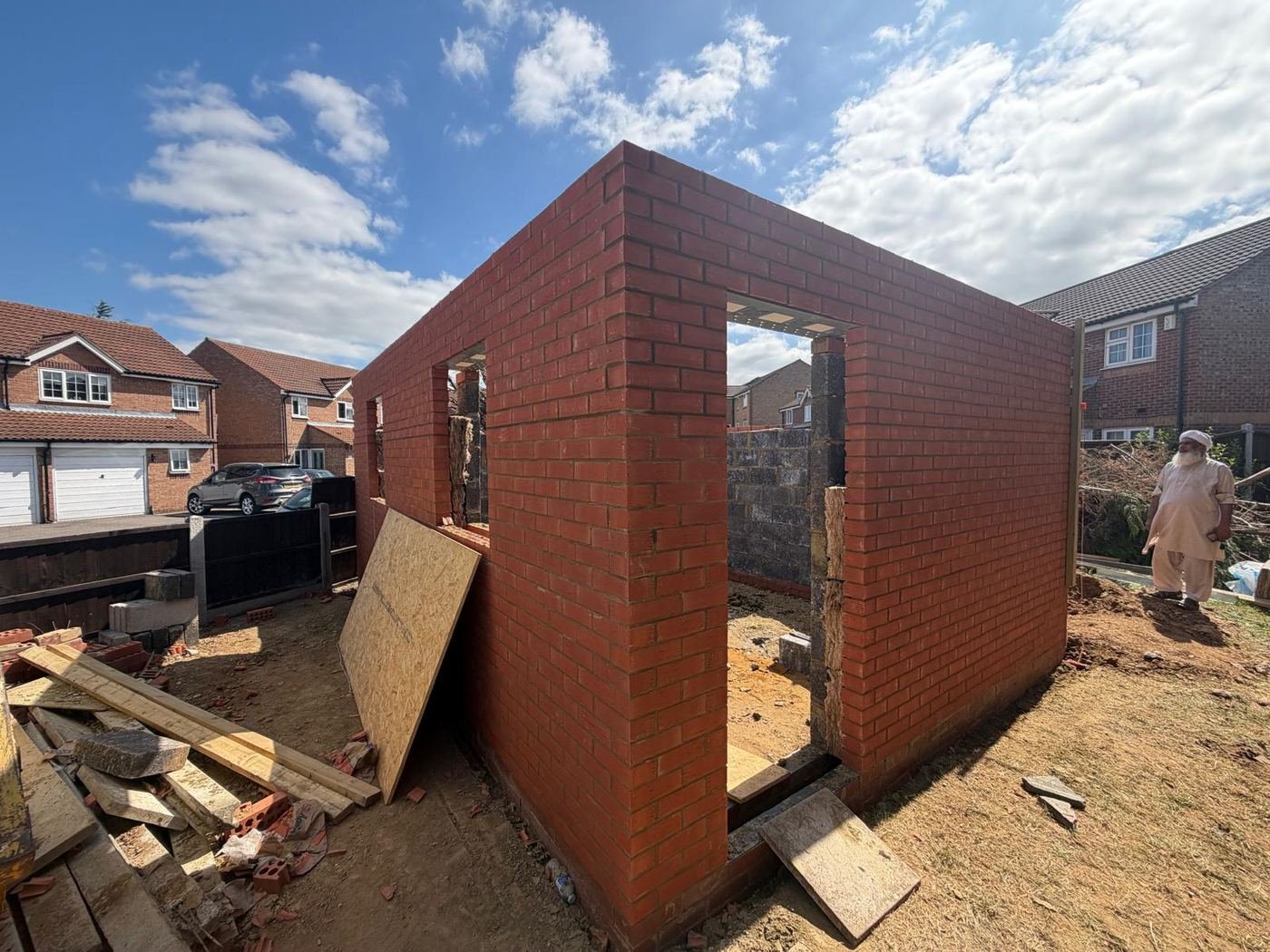 Cavity brick walls rising with window openings formed